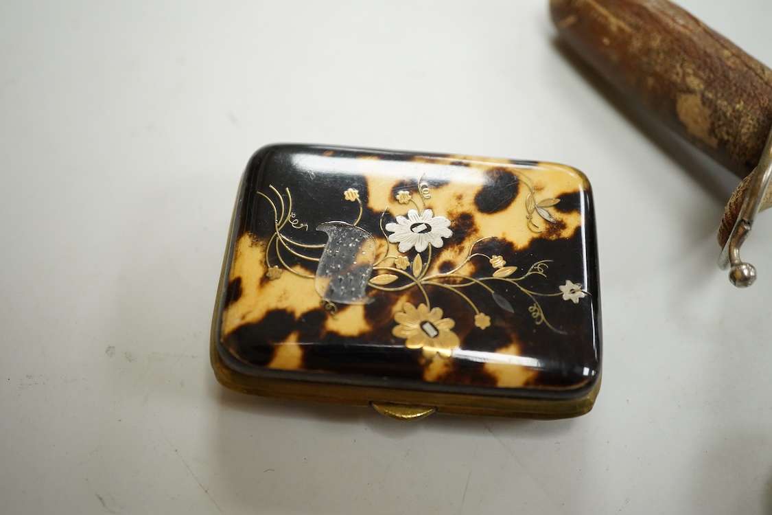 A George V engine turned silver mounted rectangular cigarette box, Birmingham, 1923, 17.7cm, a sterling mounted pepper grinder, four weighted sterling condiments and a small plated tray.